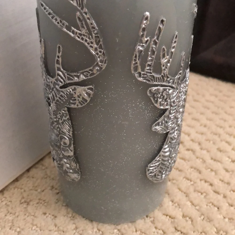 Pier 1 candle deer motif. Unused. Grey, blue, silver. 3” wide, 6” high